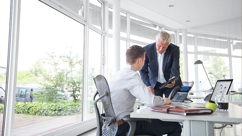 Team collaborating with Cisco video conferencing and IT solutions